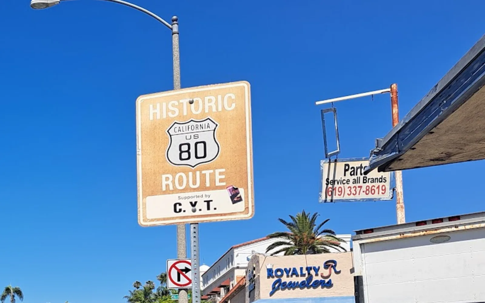 Historic US 80 route sign and commercial facade along La Mesa Boulevard.