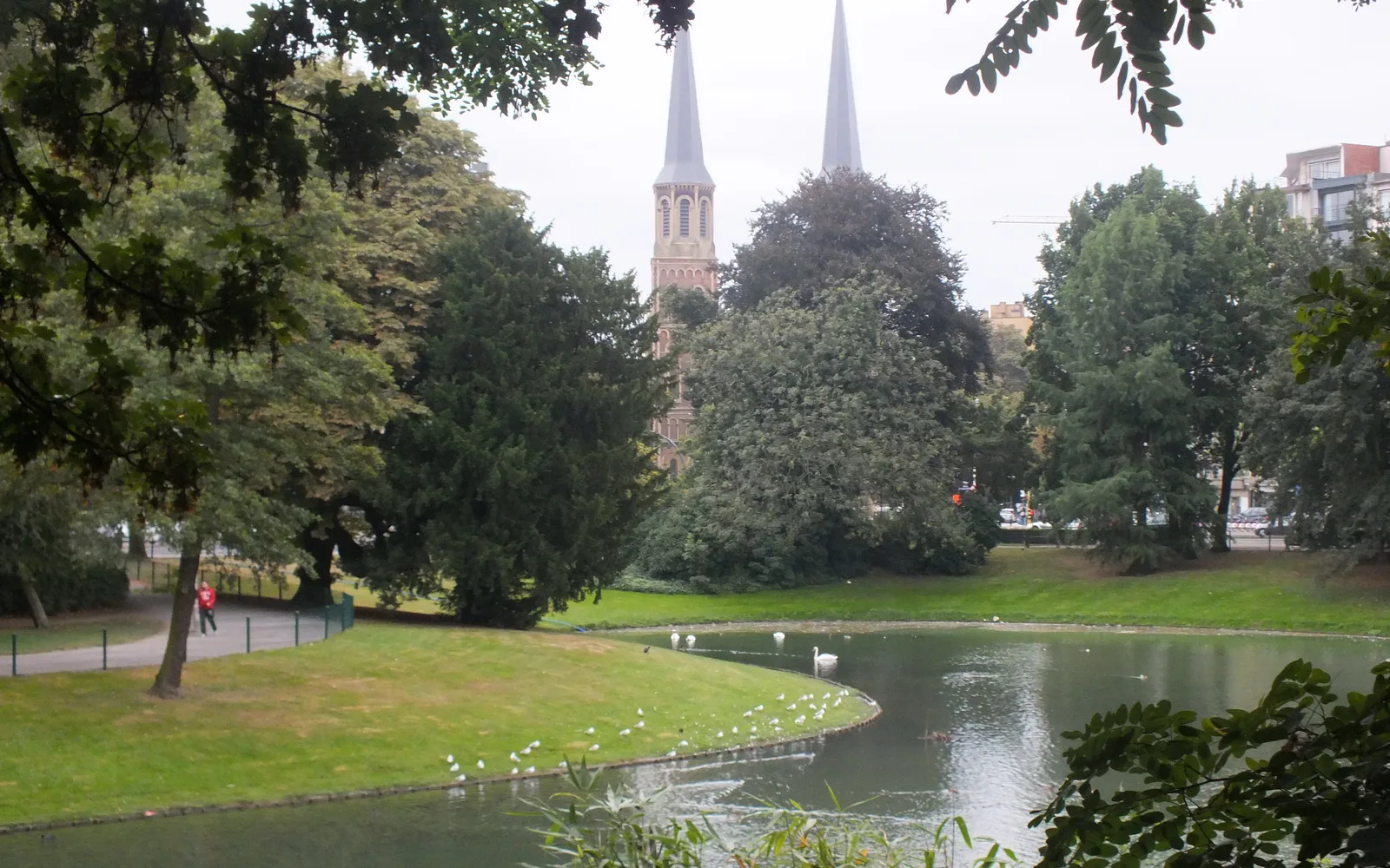 An urban park with green spaces, paths, and trees for community gathering